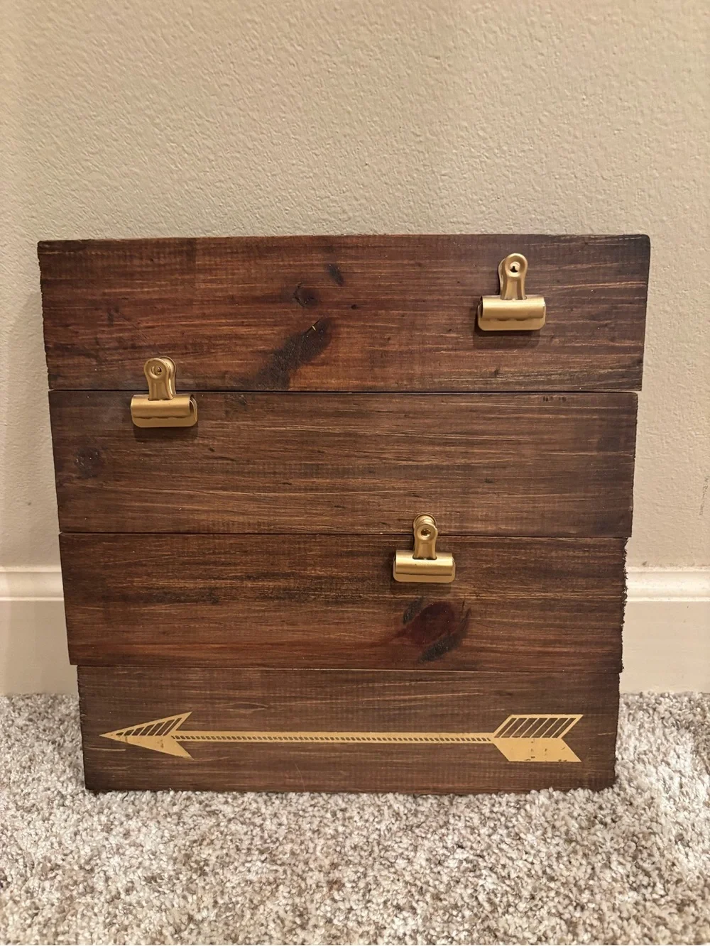 Wooden square decor with three gold clips to hold photos.